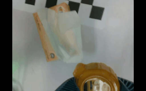 Generated real-world rollout for picking up a tape measure, close view